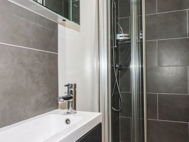 A bathroom featuring a sink and a shower at Apartment 3 in Newquay