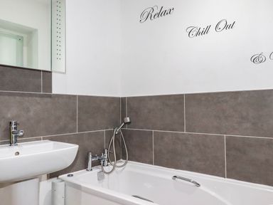 A bathroom with a sink and bathtub at Apartment 3 in Newquay
