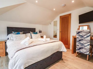 A bedroom with a bed and desk at Apartment 3 in Newquay