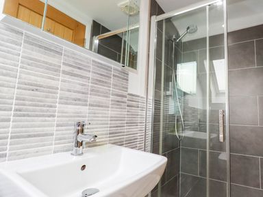 A bathroom with a sink and shower at Apartment 3 in Newquay