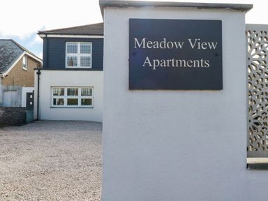 A sign for Meadow View Apartments in an outdoor area