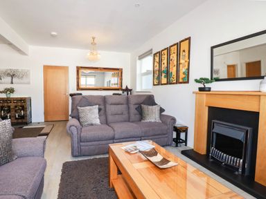 A living room with a sofa and coffee table at Apartment 1 in Newquay