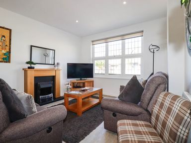 A living room with a sofa and coffee table at Apartment 1 in Newquay