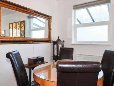 A dining room with a table and chairs at Apartment 1 in Newquay
