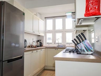 A kitchen with refrigerator and stove at Apartment 1 in Newquay