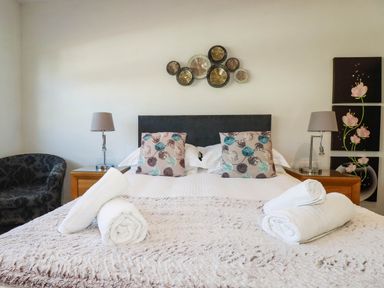 A bedroom with a bed and decorative items at Apartment 1 in Newquay