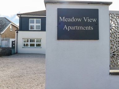 A sign for Meadow View Apartments at an outdoor location