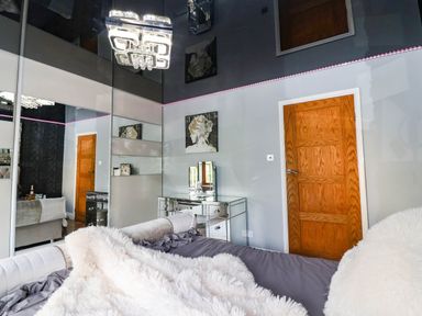 A bedroom with a bed and mirror at Severnwolf House in Gloucester