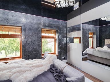 A bedroom with a bed and windows at Severnwolf House in Gloucester