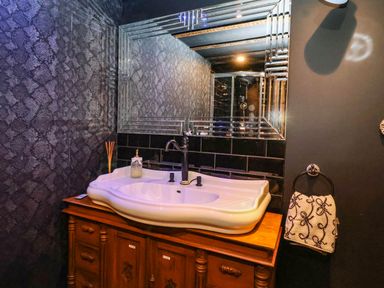 A bathroom with a sink and mirror at Severnwolf House in Gloucester