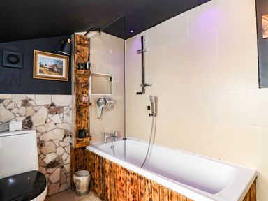 A bathroom with a bathtub and shower at Severnwolf House in Gloucester