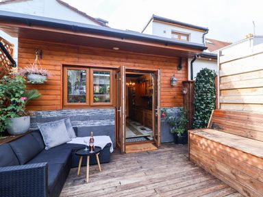 An outdoor area with seating and a wooden structure at Severnwolf House in Gloucester