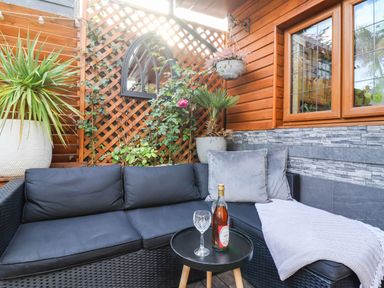 An outdoor seating area with a sofa and table at Severnwolf House in Gloucester