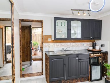 A kitchen with cabinets and sink at Severnwolf House in Gloucester