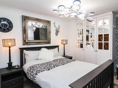 A bedroom with a bed and nightstands at Severnwolf House in Gloucester