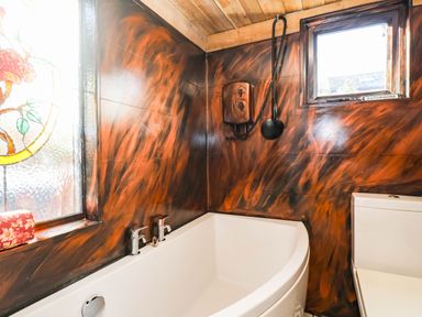 A bathroom with a bathtub and toilet at Severnwolf House in Gloucester