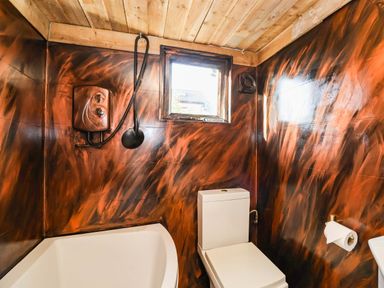 A bathroom with a bathtub and toilet at Severnwolf House in Gloucester