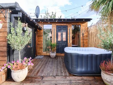An outdoor area with a hot tub and plants at Severnwolf House in Gloucester