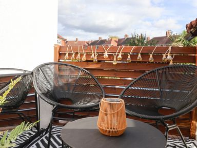 A balcony with black chairs and a table at Severnwolf House in Gloucester