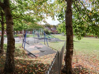 A playground with swings and equipment at Severnwolf House in Gloucester
