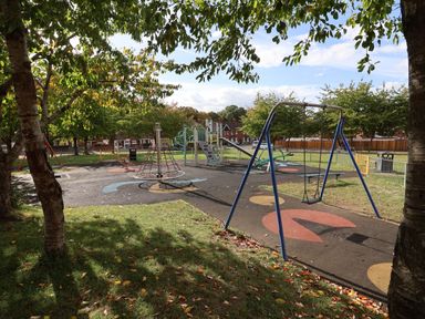 A playground with swings and climbing frame at Severnwolf House in Gloucester