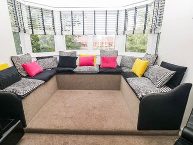 A snug area with seating and cushions at 21 Ferrara Square Swansea