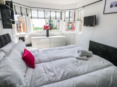 A bedroom with a bed and dresser at 21 Ferrara Square Swansea