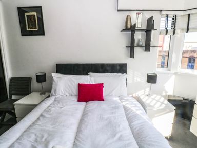 A bedroom with a bed and nightstands at 21 Ferrara Square Swansea