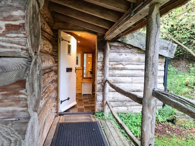An entrance with a door and pathway at Thimble Lodge in Gunnislake