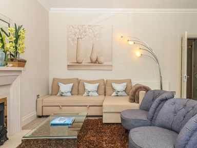A living room with a sofa and armchair at 1 Embankment House in Dartmouth