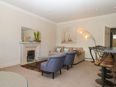 A living room with a sofa and armchair at 1 Embankment House in Dartmouth