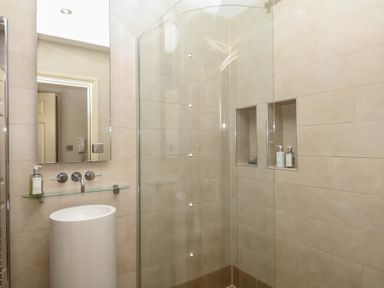 A bathroom with a shower and sink at 1 Embankment House in Dartmouth