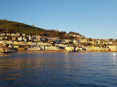 A coastal view of houses along a waterfront at 1 Embankment House in Dartmouth