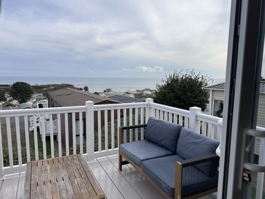 A patio with a sofa and table overlooking the ocean at Club Sahara Sandy Bay, Exmouth