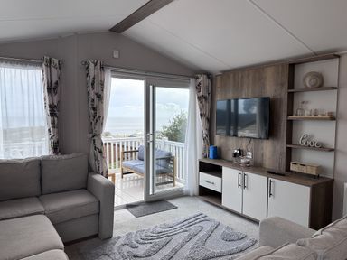 A living room with a sofa and television at Club Sahara, Sandy Bay, Exmouth