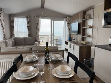 A living room with a sofa and dining table at Club Sahara Sandy Bay, Exmouth
