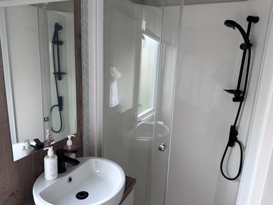 A bathroom with a sink and shower at Club Sahara Sandy Bay, Exmouth
