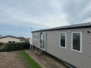 A mobile home with a patio and windows at Club Sahara Sandy Bay, Exmouth