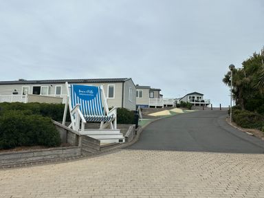 An outdoor area with a large chair and buildings at Club Sahara Sandy Bay, Exmouth