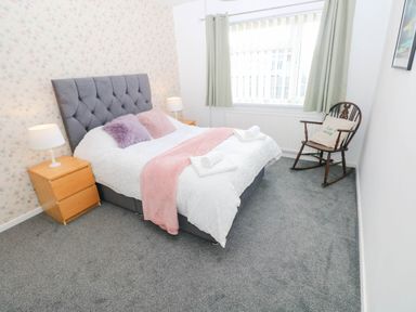 A bedroom with a bed and nightstands at 24 Little Castle Grove in Hubberston