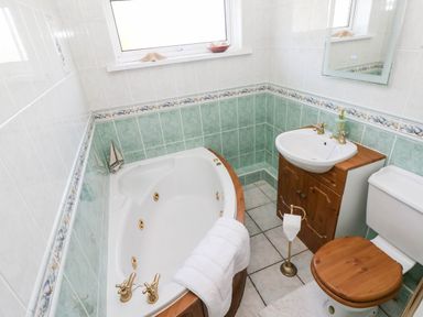 A bathroom with a bathtub and sink at 24 Little Castle Grove in Hubberston