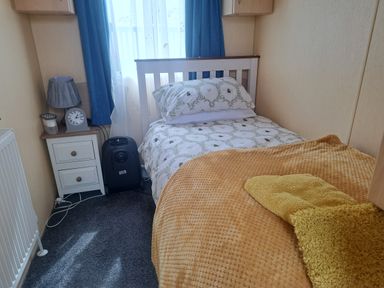 A bedroom with a single bed and a nightstand at Chapel Farm Holiday Park No 6 Bunnies View Appleby-in-Westmorland
