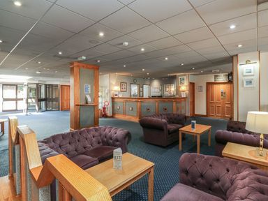 A lobby with couches and a reception desk at Guillemot in Kingsteignton