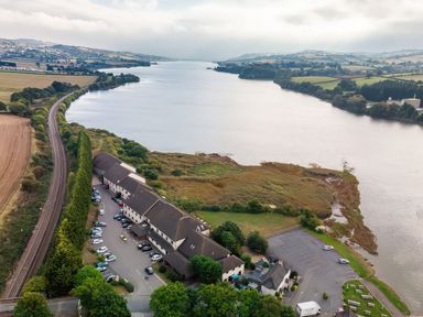 An aerial view of a river and buildings at Egret in Kingsteignton