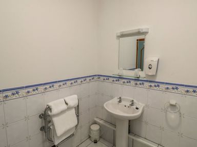 A bathroom with a sink and towels at Avocet in Kingsteignton