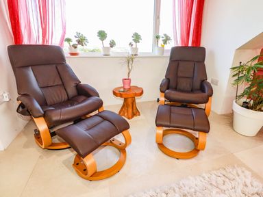 A living room with recliner chairs and a side table at Harber Rise in Carlyon Bay