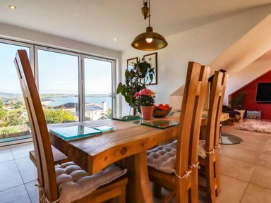 A dining room with a table and chairs at Harber Rise, Carlyon Bay