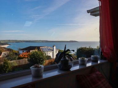 A view of the ocean and coastline from a window at Harber Rise in Carlyon Bay