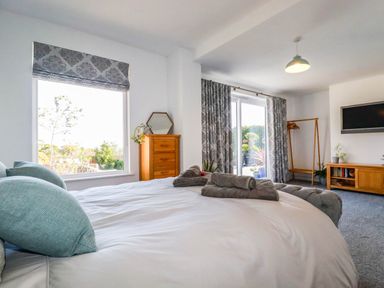 A bedroom with a bed and window at Harber Rise in Carlyon Bay