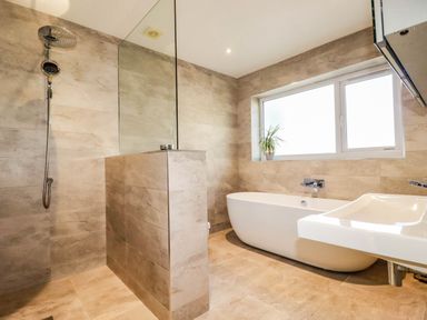 A bathroom featuring a shower, bathtub, and sink at Harber Rise in Carlyon Bay